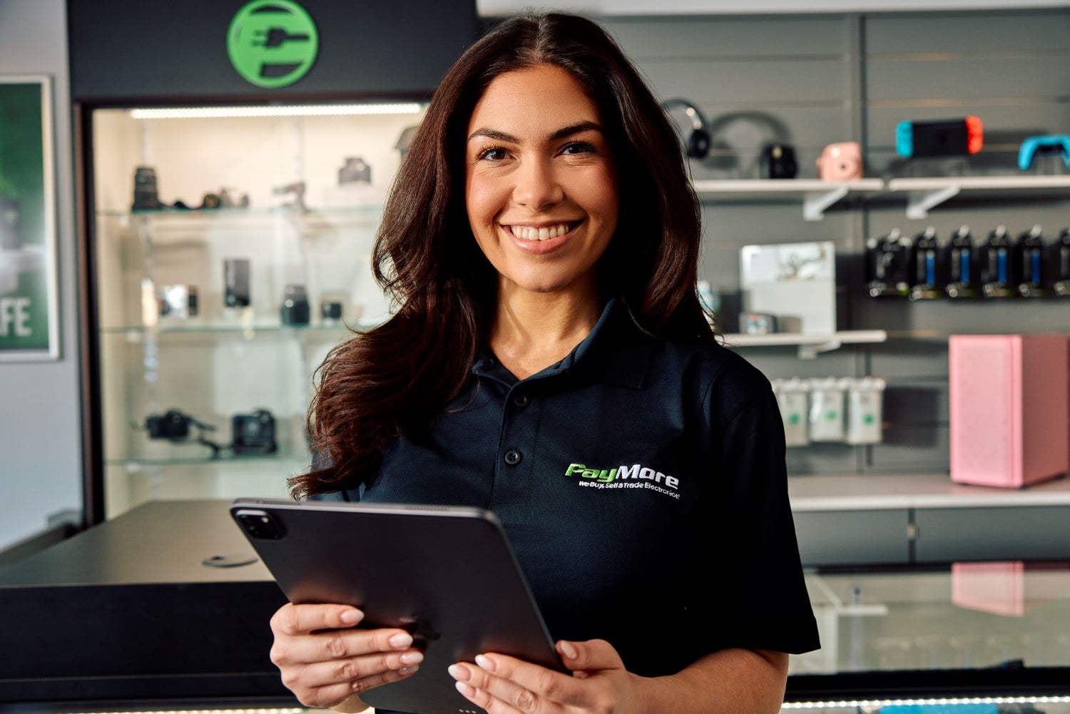 paymore employee holding a tablet and smiling